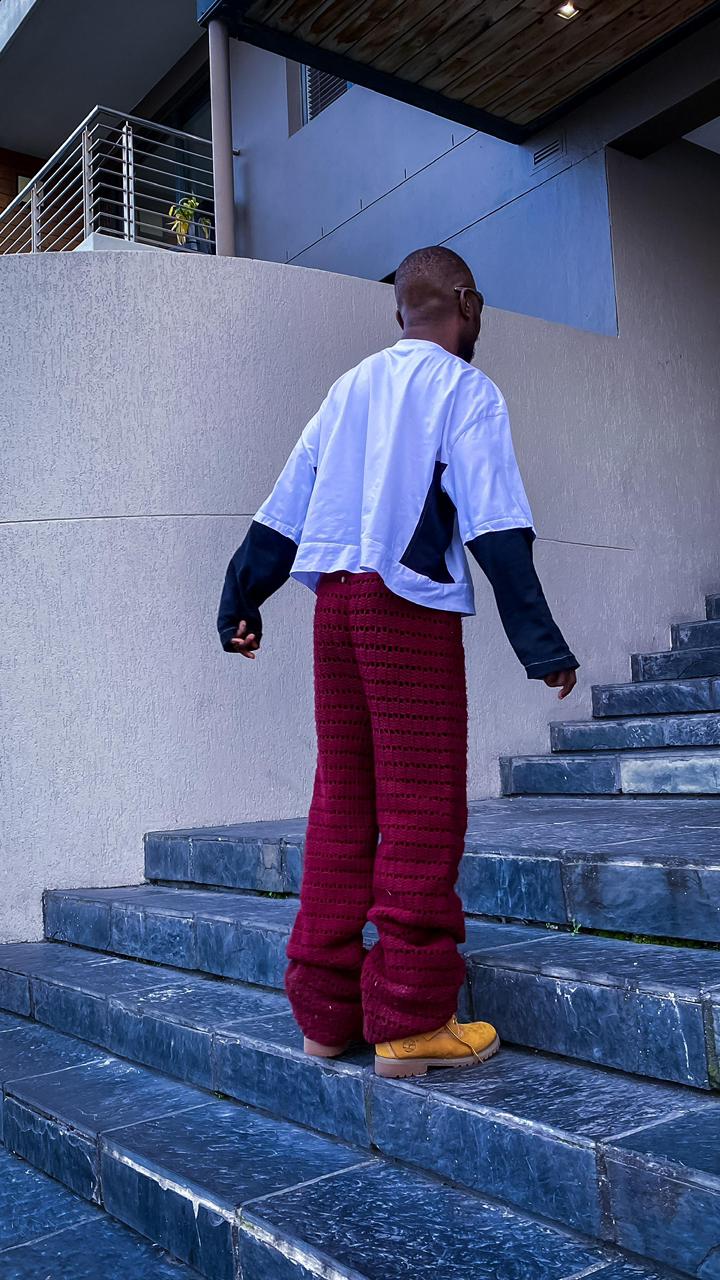Man in crochet trousers, back view